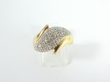 a close up of a gold and diamond ring on a white surface
