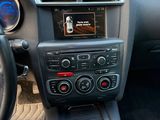the interior of a car with a steering wheel and dashboard controls