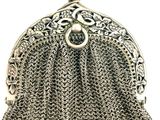 a silver purse with a chain around it and a clasp