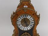 a clock that is sitting on a table with a key
