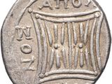 an old silver coin with a drum on it