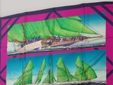 two pictures of a sailboat with green sails on it