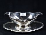 a silver plate with a saucer on it on a black background