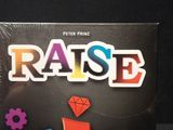 a board game called raise on a black table