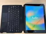 a tablet and a keyboard on a desk next to each other