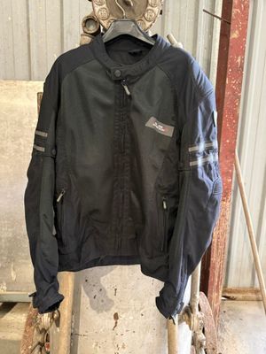 a black jacket hanging on a rack in a garage