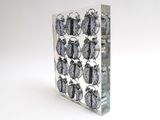 a glass block with a clock on it on a white background