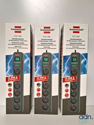 three boxes of power strips sitting next to each other on a table