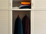 an image of a closet with clothes and clothes on it