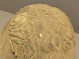 a close up of a clay sculpture of a woman ' s head
