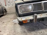 an old car that is parked in a garage