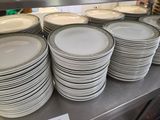 a lot of plates that are stacked on the counter