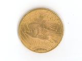 a gold coin with a eagle on it on a white surface