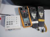 three multimeters sitting next to each other on a table