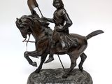statue of a man on a horse with a flag on its back