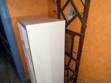 a tall white refrigerator in the corner of a room