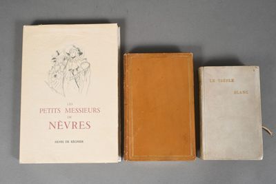 three books are sitting on a table next to each other