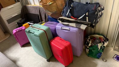 many pieces of luggage sitting on the floor in a room