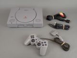 a video game console and a game controller on a table