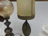 a table with a vase and a lamp on it