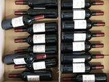 many bottles of wine in a box on the table