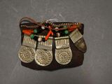 a small purse that has a bunch of coins on it