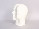 a white mannequin head sitting on a table