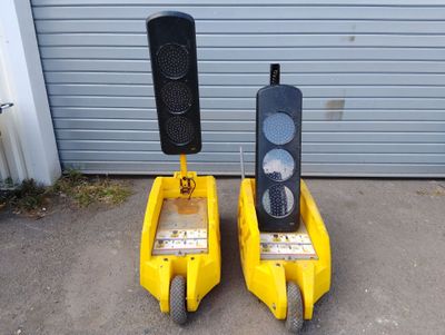 two yellow pedals with a traffic light attached to them