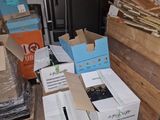 many boxes that are sitting on a pallet in a warehouse