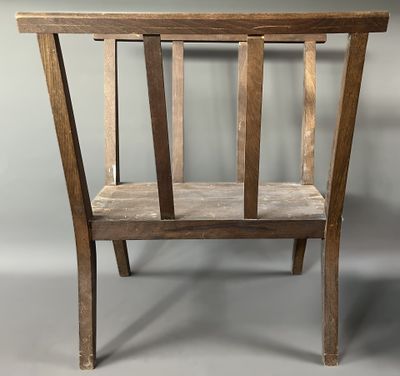 a wooden chair with a wooden seat on a gray background