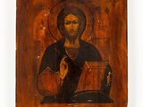 an old wooden icon of jesus holding a book