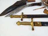 many different types of knives on the table