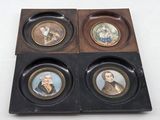 four miniature portraits of people in a wooden box on a white surface