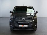 the front view of a black van parked in a white room