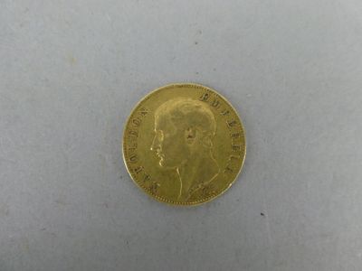 a close up of a gold coin on a white surface