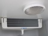 a white air conditioner that is hanging from the ceiling