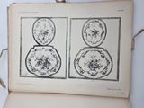 an open book with a drawing of four plates on it