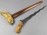 two different types of knifes on a table with a wooden handle