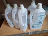several bottles of liquid sitting on top of a counter next to each other