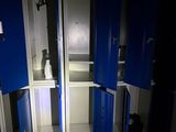 two blue lockers in the corner of a room