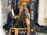 an image of a construction vehicle with a crane attached to it ' s back