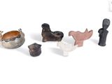 several pieces of pottery sitting on top of a white surface