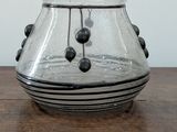 a glass vase that is sitting on a wooden table