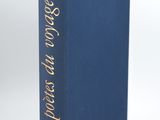 a blue book with gold lettering on it sitting on a white surface