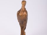 bronze statue of a pelican on a white background