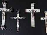 three silver crosses with a cross on each of them and a cross on the other