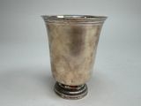 a silver cup that is sitting on top of a table