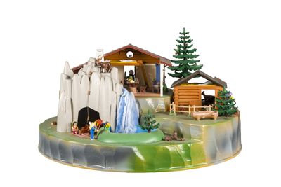 une figurine représentant une crèche avec une mangeoire et une femme