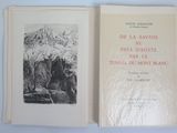an open book with a picture of a mountain in the background