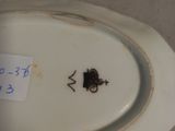 a white plate with a bug on it and a sticker on it